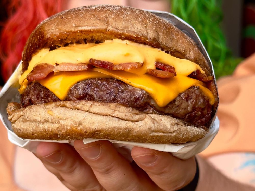 Hambúrguer com queijo derretido e bacon em pão artesanal, imagem usada em conteúdo sobre do que é feito hambúrguer.